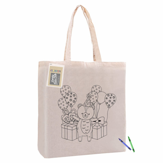 A natural calico tote bag featuring a bear design with balloons and gifts, alongside a crayon for colouring.