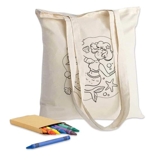 A cream-coloured tote bag featuring a colouring design, accompanied by crayons and a small notebook.