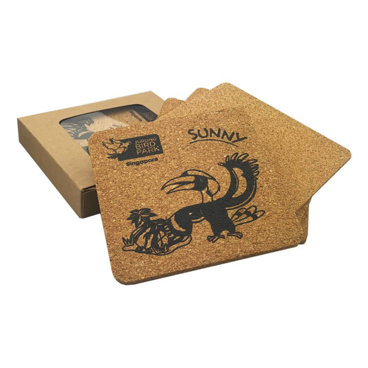 A square set of four cork coasters featuring a bird design, packaged in a brown box.