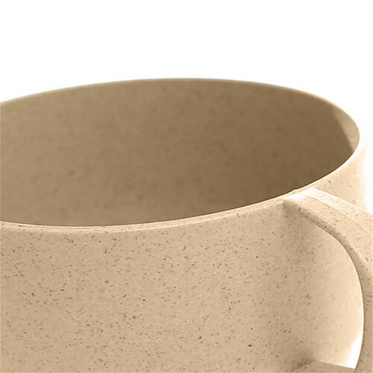 A wheat straw coffee cup in a natural beige colour with a handle and a smooth interior. It features a logo.