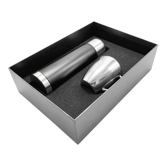 A drink bottle and a stainless steel cup in a black gift box with foam padding. The bottle is black with silver accents.
