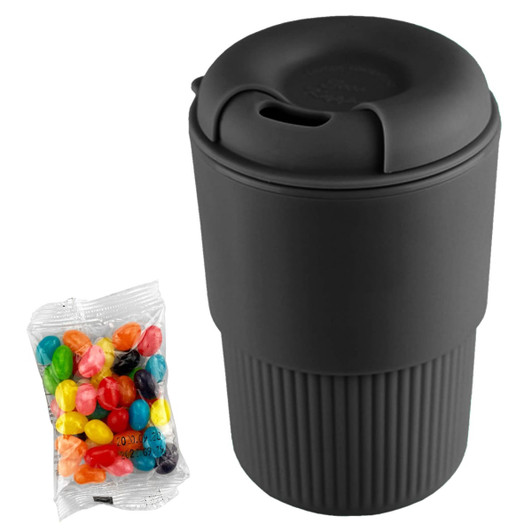 A reusable black coffee cup with a textured body, accompanied by a bag of colourful jelly beans.