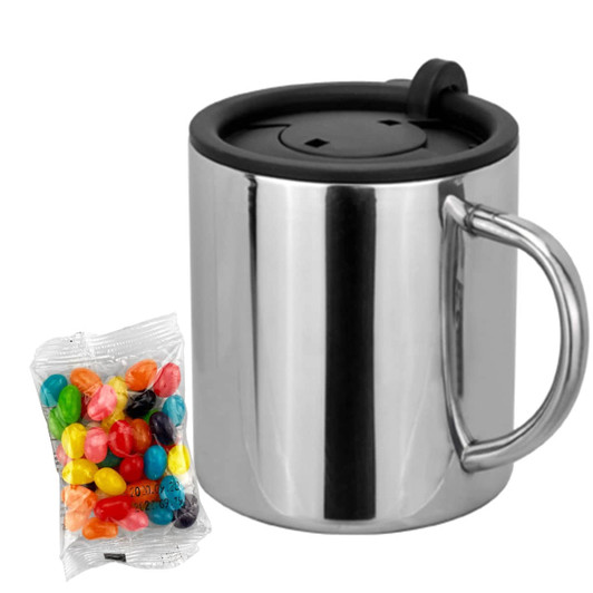 A stainless steel coffee mug with a black lid and handle, accompanied by a pack of colourful jelly beans.