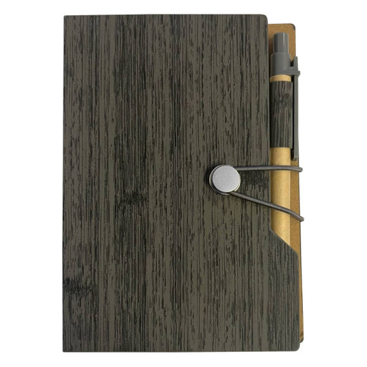 A green wooden-textured sticky note pad with a pen secured by a band. The design includes a pocket for loose notes.