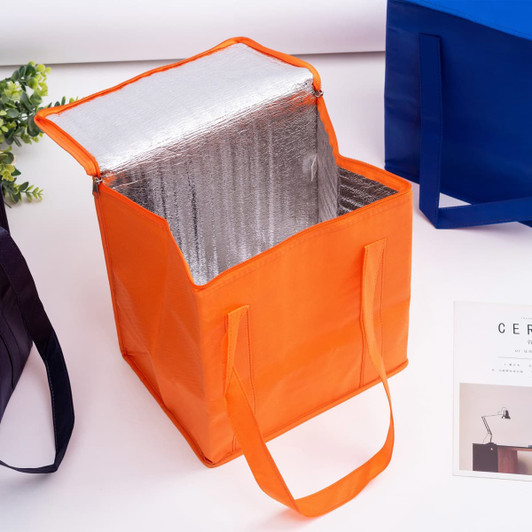An orange non-woven cooler bag with a zipped lid, featuring a silver insulated interior and sturdy handles.