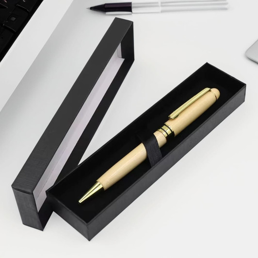A wooden pen with gold accents in a sleek black presentation box. The box is open, revealing the pen inside.