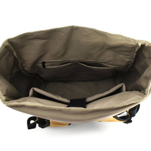 An open beige laptop backpack with compartments and pockets inside. It features a logo on the exterior.