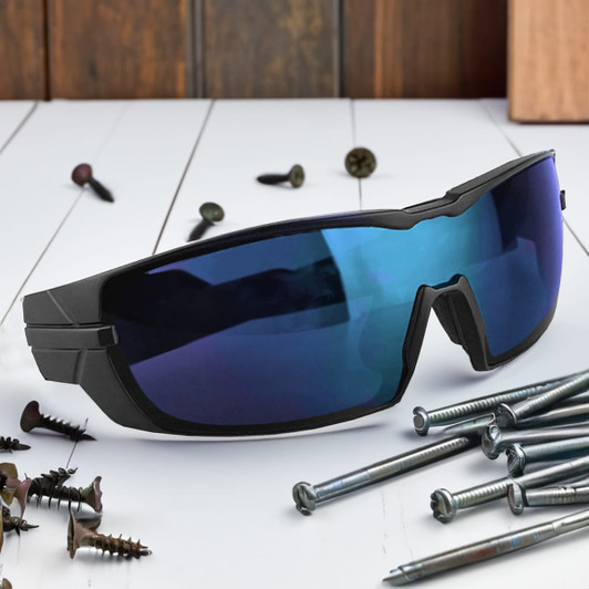 A pair of black sunglasses with blue lenses, resting on a surface with scattered screws and nails.