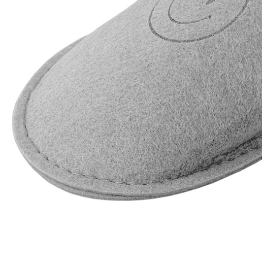 A grey felt slipper featuring a stitched edge and a small logo.