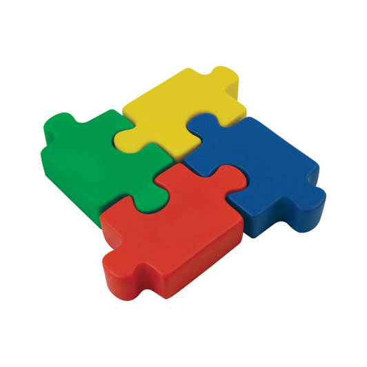 A collection of colourful jigsaw puzzle pieces in red, green, yellow, and blue. The pieces are chunky and made of soft material.