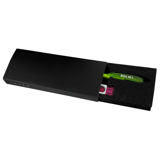 A black gift box containing a green pen and a pink stylus, showcasing a sleek design and a foam insert for protection.