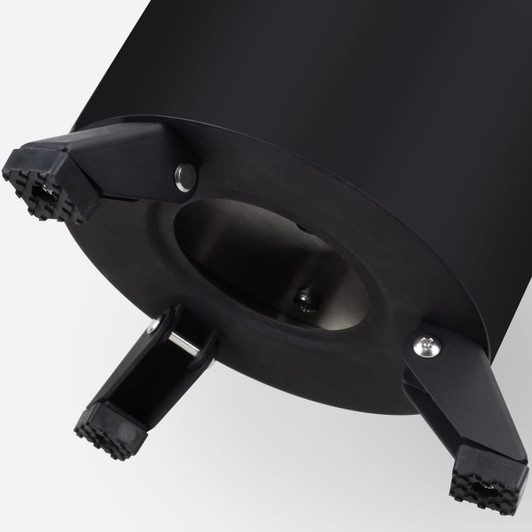 A black campfire cooker base with three sturdy legs for stability. It features a circular design and a metallic interior.