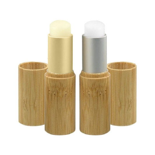 Two bamboo lip balm sticks in natural bamboo holders, one with a creamy yellow balm and the other with a white balm.