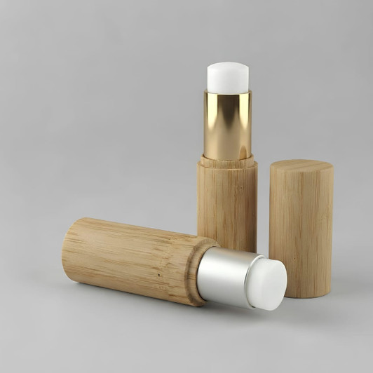 Two bamboo lip balm sticks in natural bamboo casing, featuring a gold and silver top.