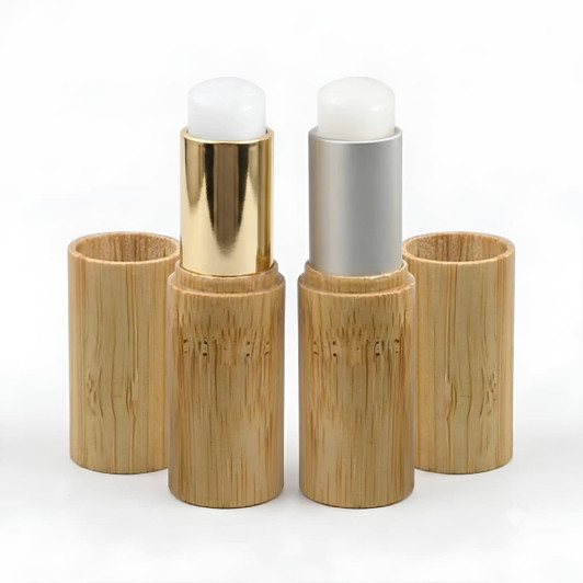 Bamboo lip balm sticks in natural bamboo holders, featuring gold and silver tops. Eco-friendly design for personal care.