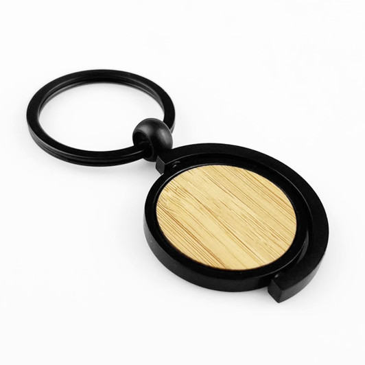 A black key ring with a circular bamboo disc at the centre, featuring a modern design.