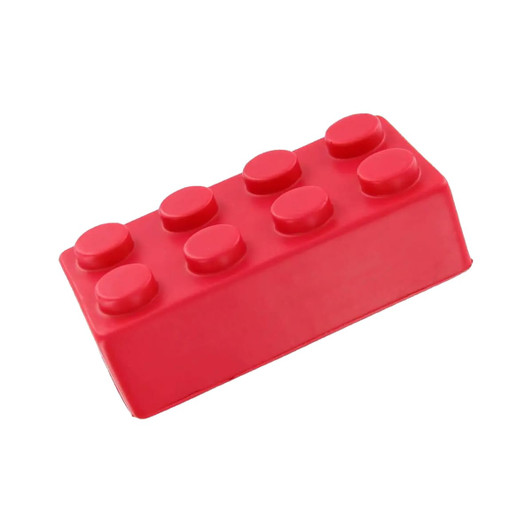 A red stress building block shaped like a toy brick, featuring rounded knobs on top. It has a logo on one side.