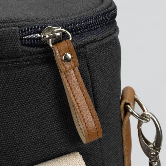 A black wine cooler bag with a textured surface, featuring a zipper and a tan leather handle.