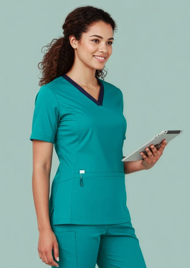 A women's teal scrub top featuring a V-neck, short sleeves, and a pocket, with a dark blue trim.