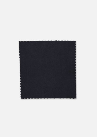 A square swatch of black fabric with a textured finish, edged with a zigzag pattern.