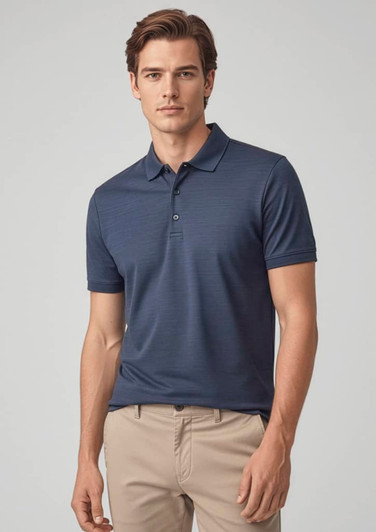 A men's short sleeve polo in navy blue, featuring a logo, styled with beige trousers.