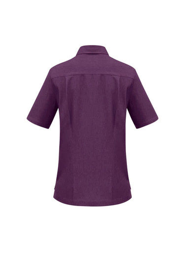 A purple overblouse with short sleeves and a collar, featuring a back yoke detail. It has a logo.