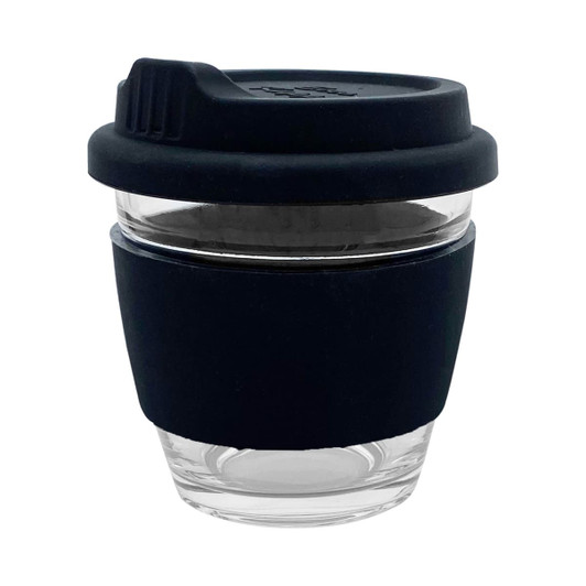 A reusable glass coffee cup with a black silicone sleeve and lid, featuring a transparent body.