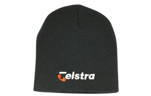 A rolled down acrylic beanie in black featuring a logo on the front.