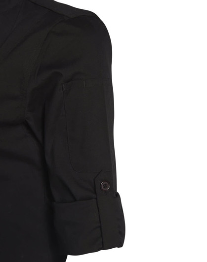 A black chef jacket featuring a rolled sleeve and a button detail, with a side pocket and a logo present.