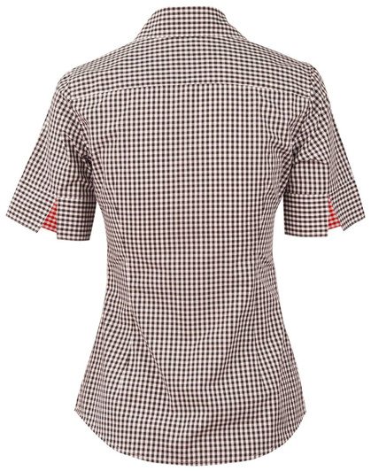 A short-sleeved women's button-up shirt in black and white gingham check with a red pattern on the sleeves. It features a logo.