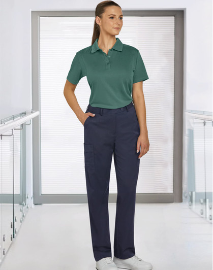 Ladies' utility cargo pants in navy, paired with a green polo shirt, displayed in a modern indoor setting.