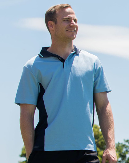 A light blue polo shirt with black contrast panels and a logo on the chest, featured on a model outdoors.
