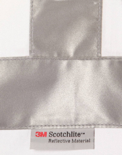 A reflective silver strip on a white fabric with a label for 3M Scotchlite reflective material.