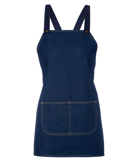 A navy denim bib apron featuring crossback straps and a front pocket. Includes branding on the design.