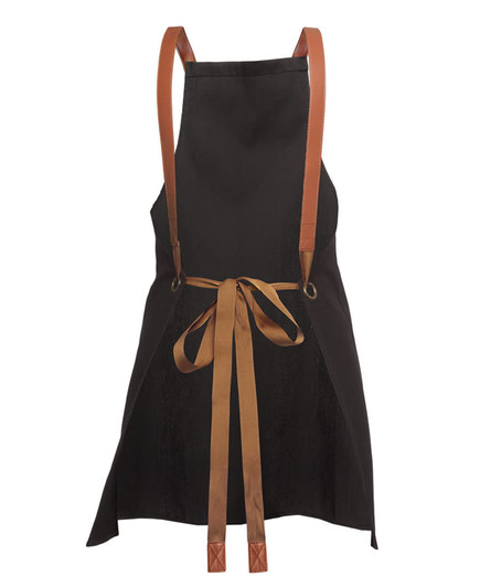 A black apron with brown cross-back straps and a tied bow at the waist. It features branding on the fabric.