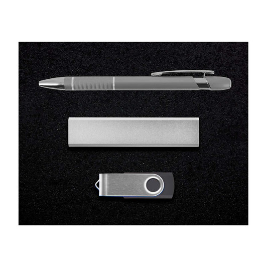 A silver pen, a sleek metal bar, and a silver USB drive arranged on a black background.