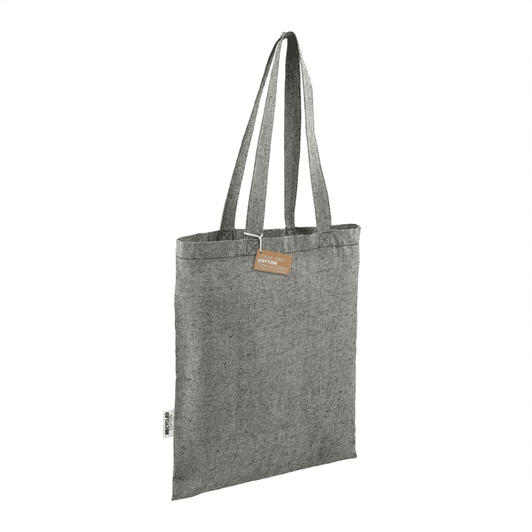 A grey recycled cotton twill tote bag with two long handles and a tag, featuring a simple design.