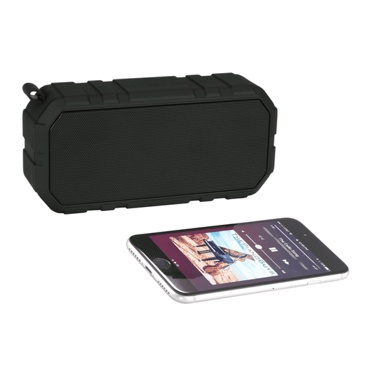 A black outdoor waterproof Bluetooth speaker next to a smartphone, featuring a textured surface and a sturdy design.