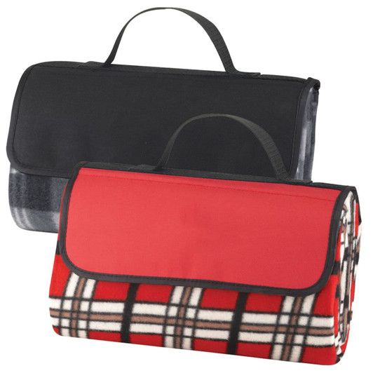 A picnic rug with a red and plaid design, featuring a black carrying handle and foldable design.