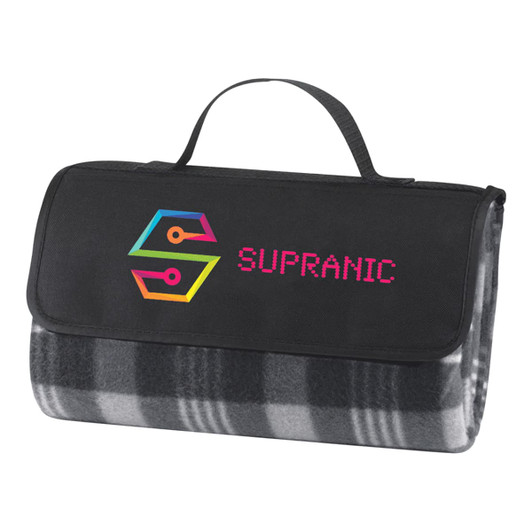 A folded picnic rug in grey and black checkered pattern with a black carrying strap and a logo on the front.
