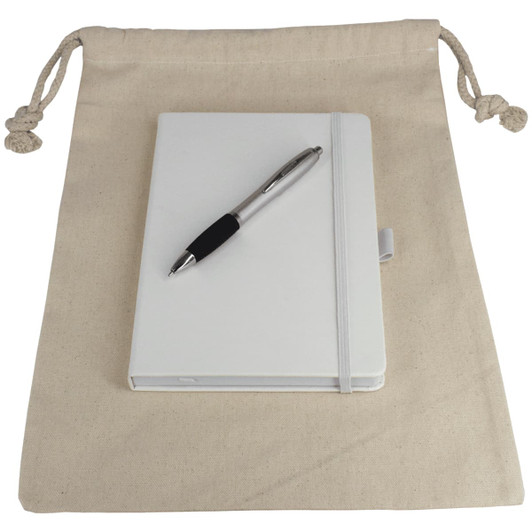 A cream drawstring bag containing a white journal book and a silver pen. The bag has a branding logo.