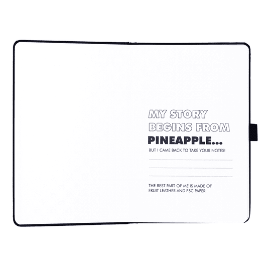 A pineapple leather bound journal with blank pages, featuring a black cover and an interior with printed text.