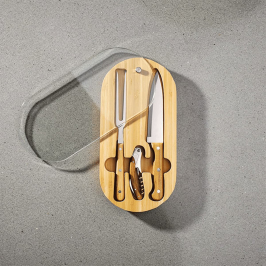 An oval bamboo knife set featuring a cheese knife, chef’s knife, and corkscrew, all with wooden handles.