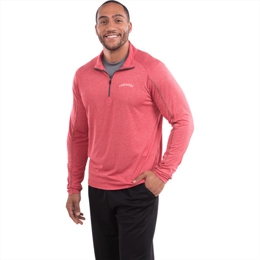 A male model wearing a red quarter-zip jumper with long sleeves and a logo on the chest.