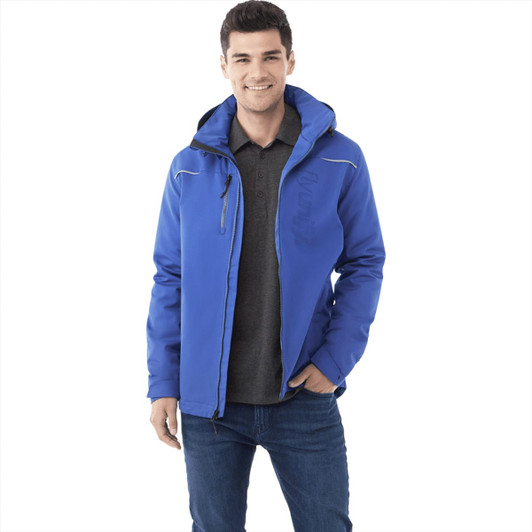 A men's fleece lined jacket in blue, featuring a hood and a zippered pocket. The model wears it over a grey polo shirt.