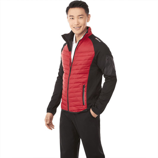 A man models a men's Banff Hybrid Insulated Jacket in red and black, featuring a zip front and two side pockets.