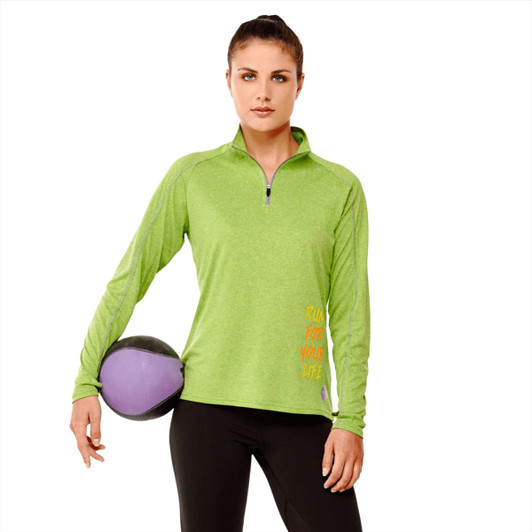 A green women's quarter zip jumper with a fitted design, featuring a branding logo and styled with black leggings.