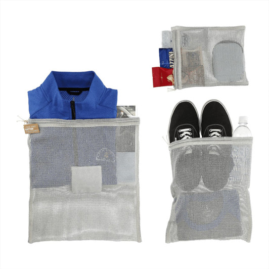 A set of recycled cotton mesh cinch pouches in grey, containing a blue shirt, shoes, and various items.