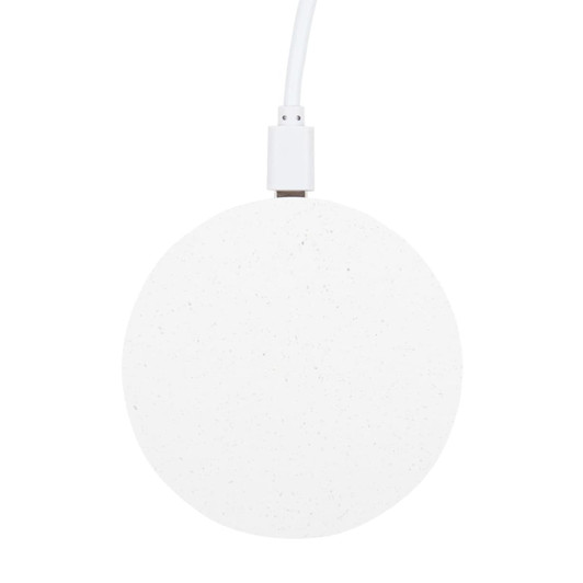 A round, white wireless charger with a textured surface and a connected charging cable.