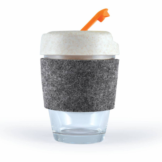 A reusable coffee cup with a clear glass base, a grey felt band, and a white lid with an orange straw.